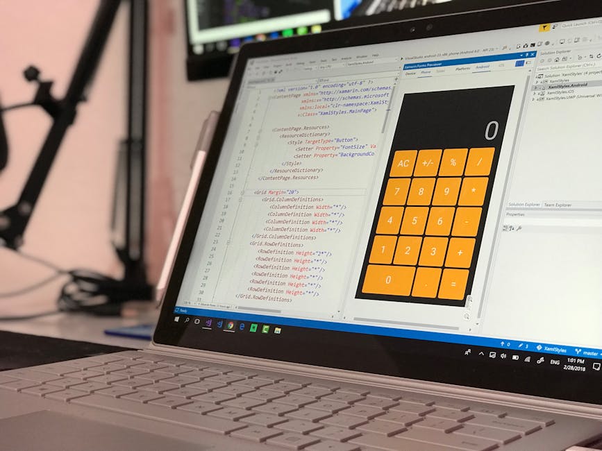 A person using a laptop with a dark-themed coding interface displayed on the screen, showcasing lines of code with syntax highlighting in green, blue, and white. The user's hands are positioned on the